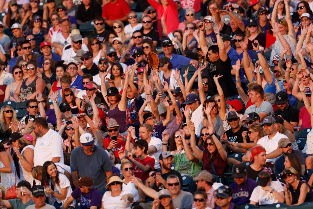 Fans take part in &quot;the wave&quot; in the sixth inning of a baseball game Tuesday, July 4, 2017, in Denver.