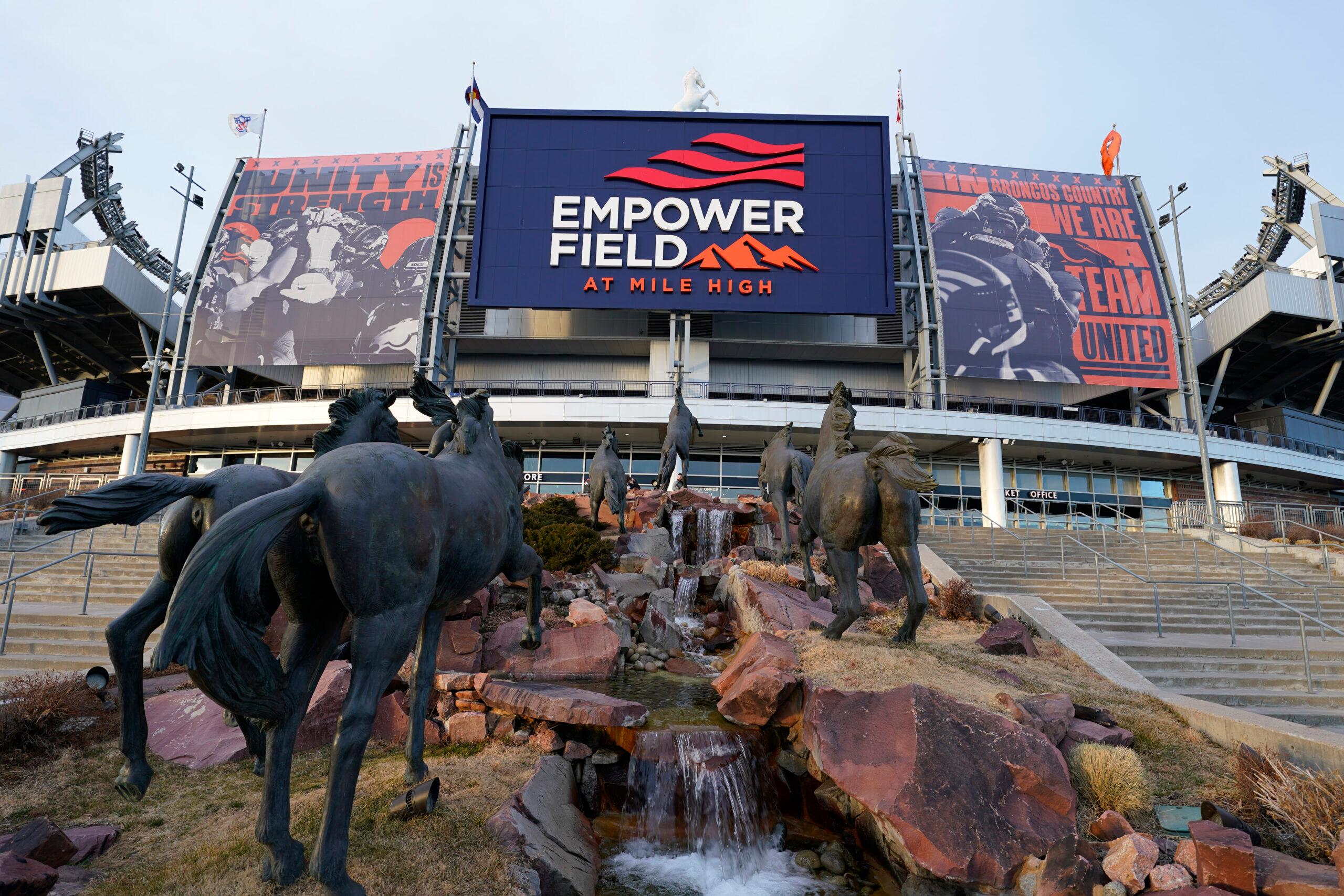 Sun illuminates Empower Field at Mile High, the home of the NFL's Denver Broncos, late Saturday, Jan. 2, 2021, in this view from the team's Ring of Fame plaza in Denver.