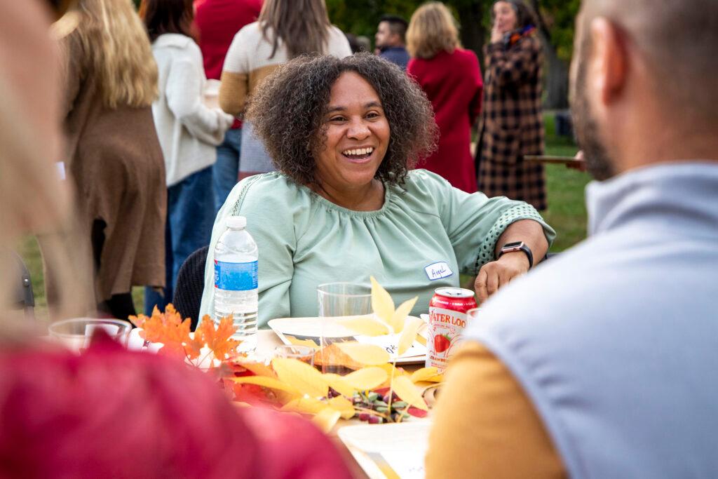 Angel Williams chats during a long table dinner at City Park. Oct. 15, 2022.