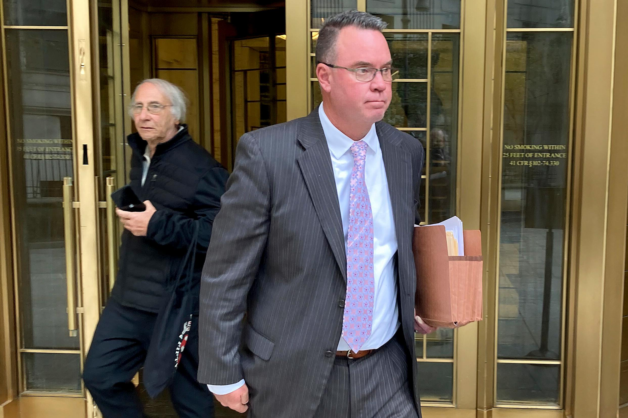 Timothy Shea, right, leaves Manhattan federal court after a jury convicted him of charges in an online campaign that raised $25 million to build a wall along the U.S.-Mexico border, Friday, Oct. 28, 2022, in New York.