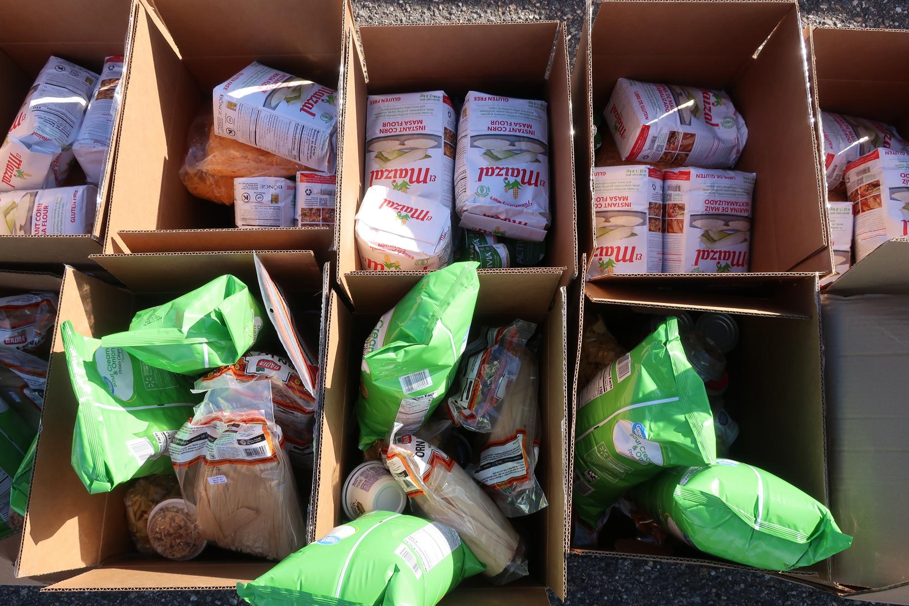 A box holding ingredients for tamales sit in rows in the parking lot of the Dick’s Sporting Goods Park in Commerce City on Dec. 2, 2022. The food is one example of offerings in the Culturally Responsive Food Initiative at the Food Bank of the Rockies.