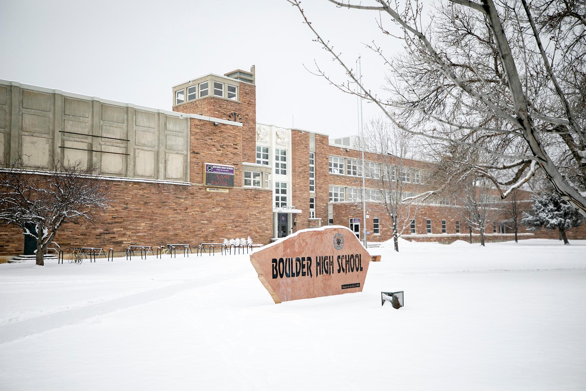 A law enforcement vehicle passes Boulder High School. Feb. 22, 2023.