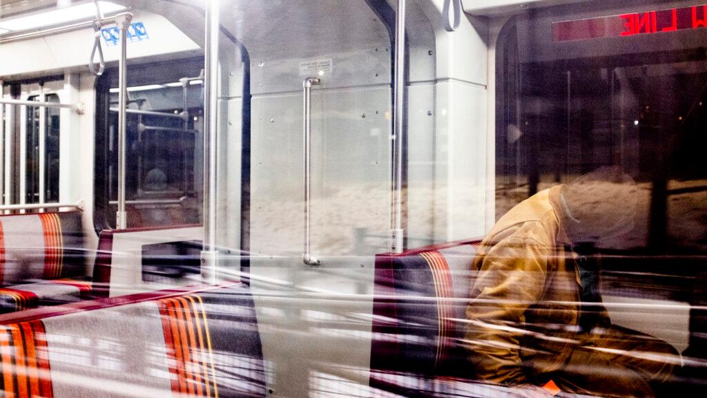 Ricci Autry closes his eyes as he rides an RTD W Line train before dawn. Feb. 22, 2023.