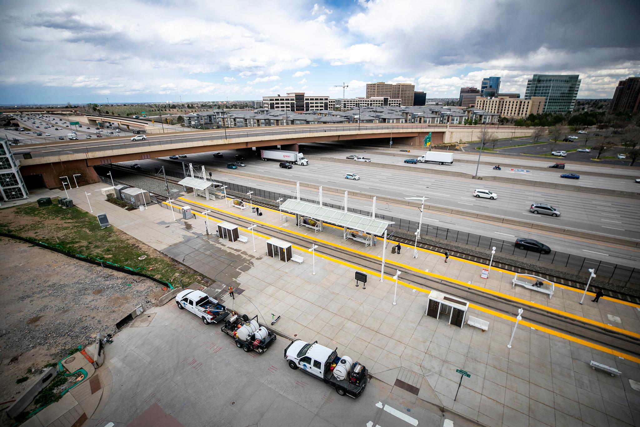 An overhead shot of a lightrail station with I-25 just beyond it.