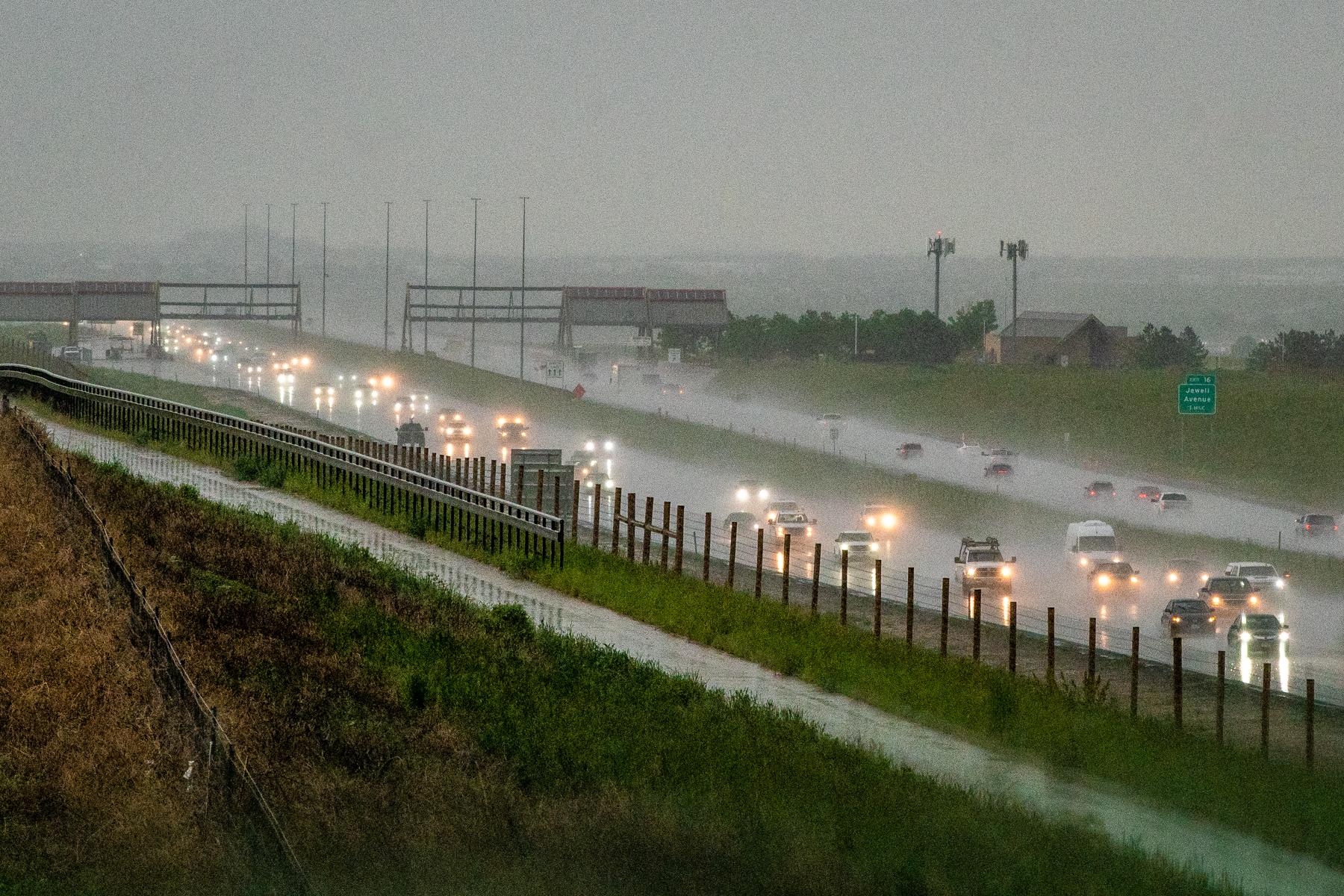 Cars on E-470 turn on their headlights in the rain