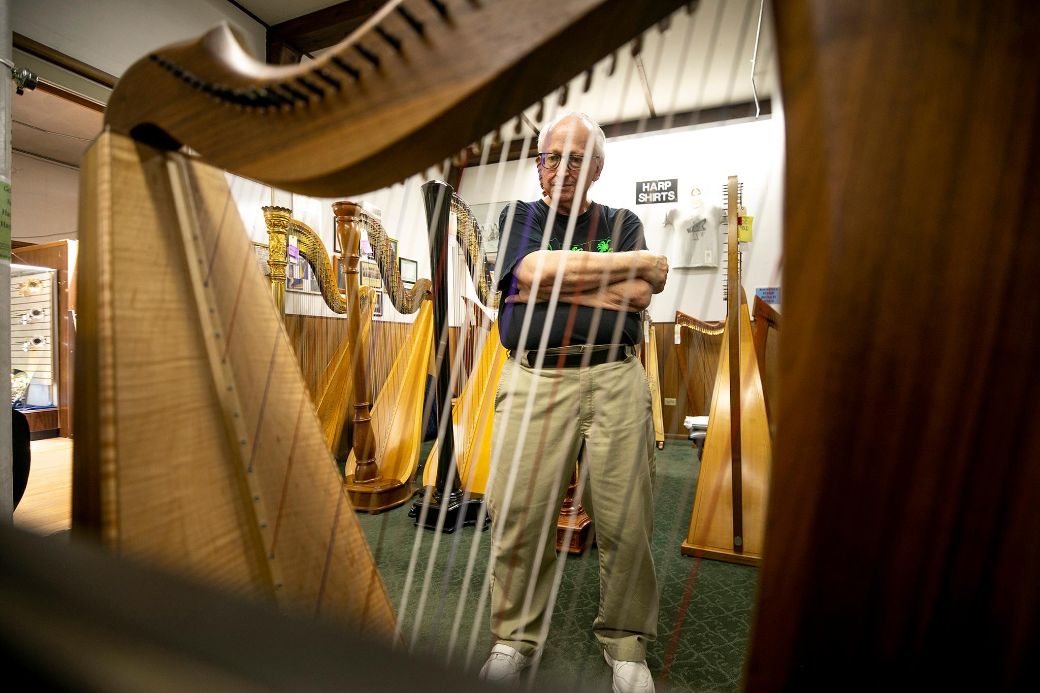 David Kolacny in the harp room of his Denver music shop. July 22, 2023.
