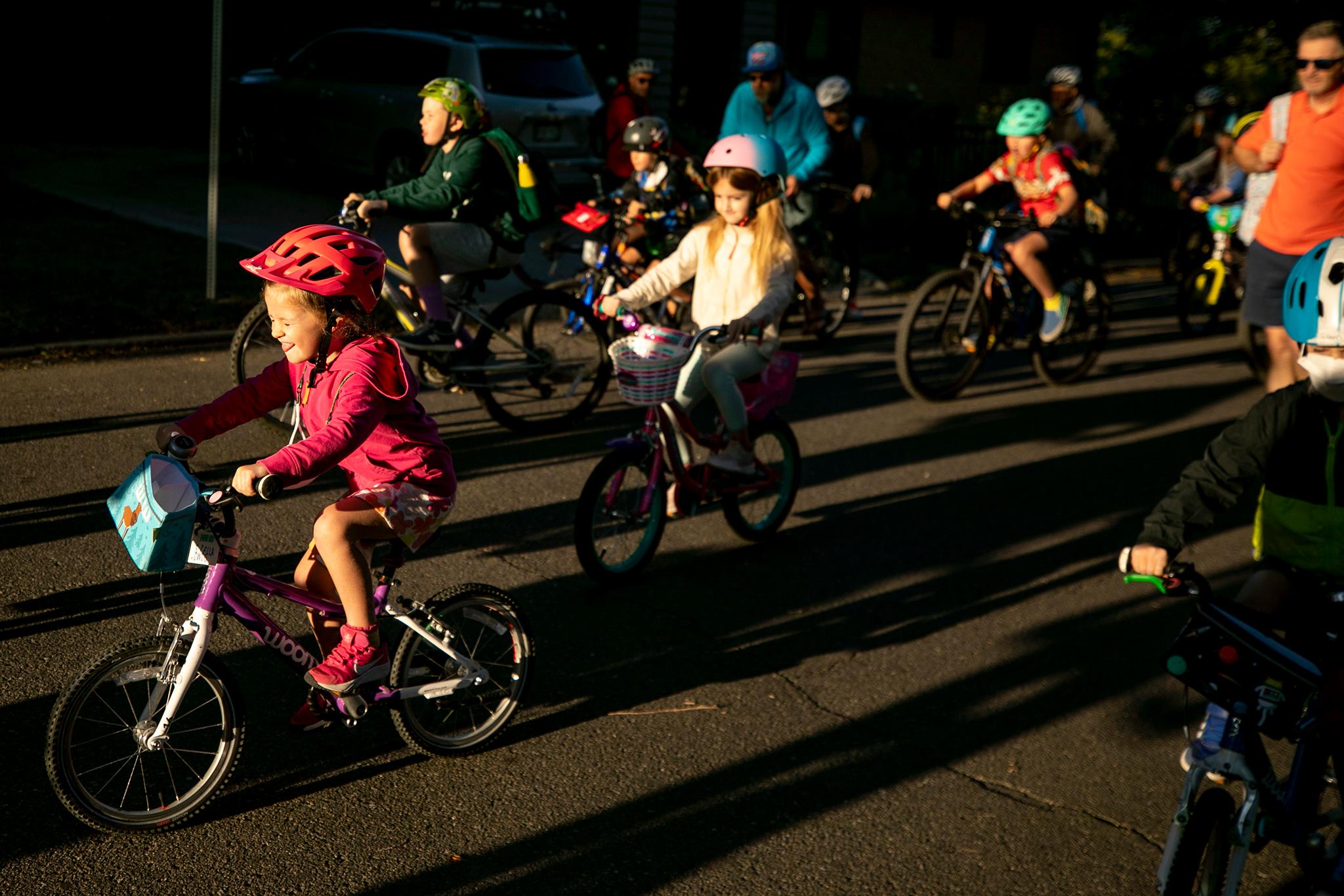 The Brown International Academy "bike bus" rides to school on Sept. 6, 2023.