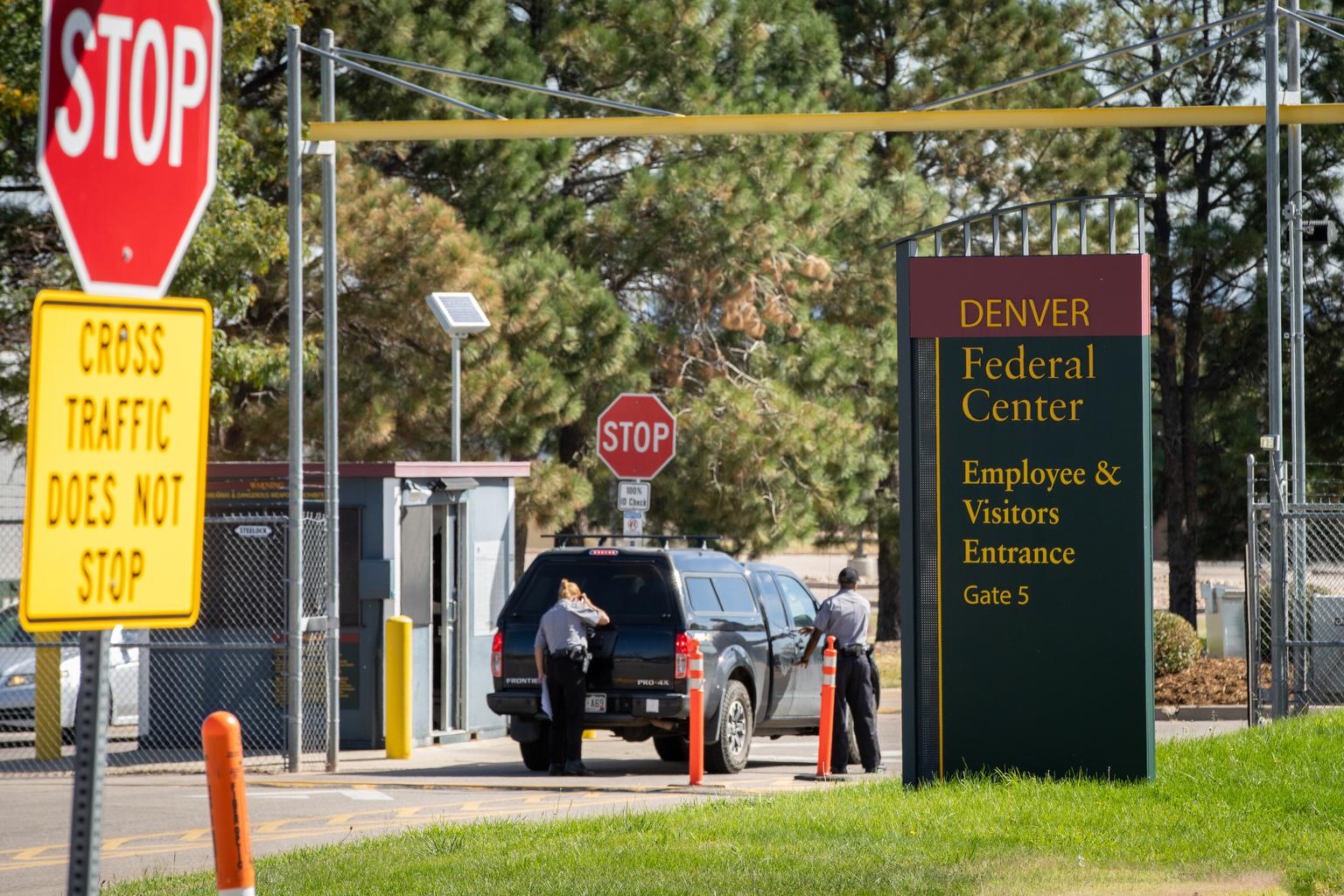 Security guards inspect a vehicle
