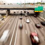 Drivers head westbound on I-70, seen from the Elyria Swansea park built above the highway. June 30, 2023.