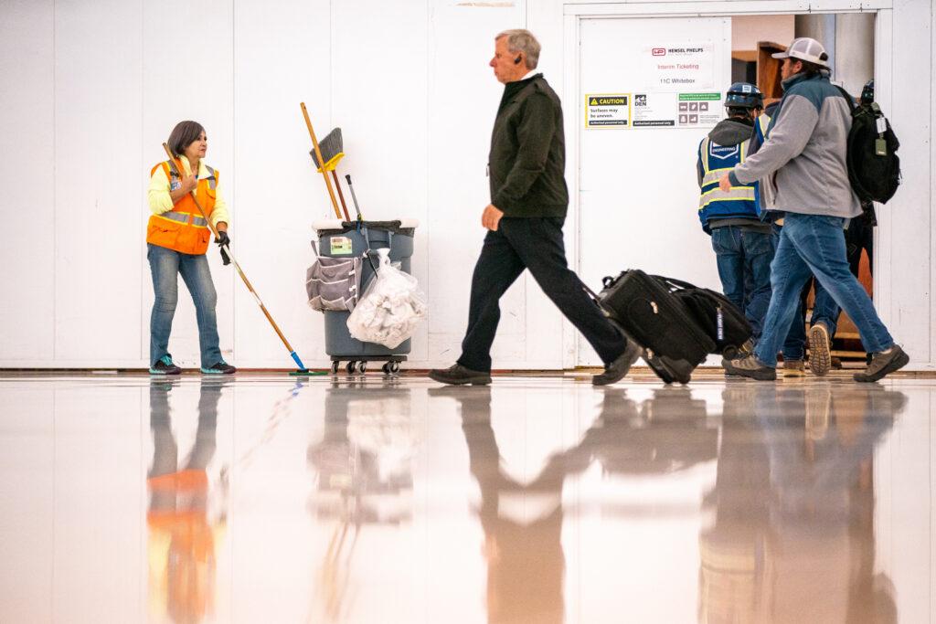 DIA AIRPORT WORKER SWEEPS FLOOR