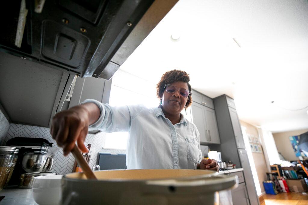 Althea Brown cooks up a pumpkin curry in her Aurora home. Dec. 13, 2023.