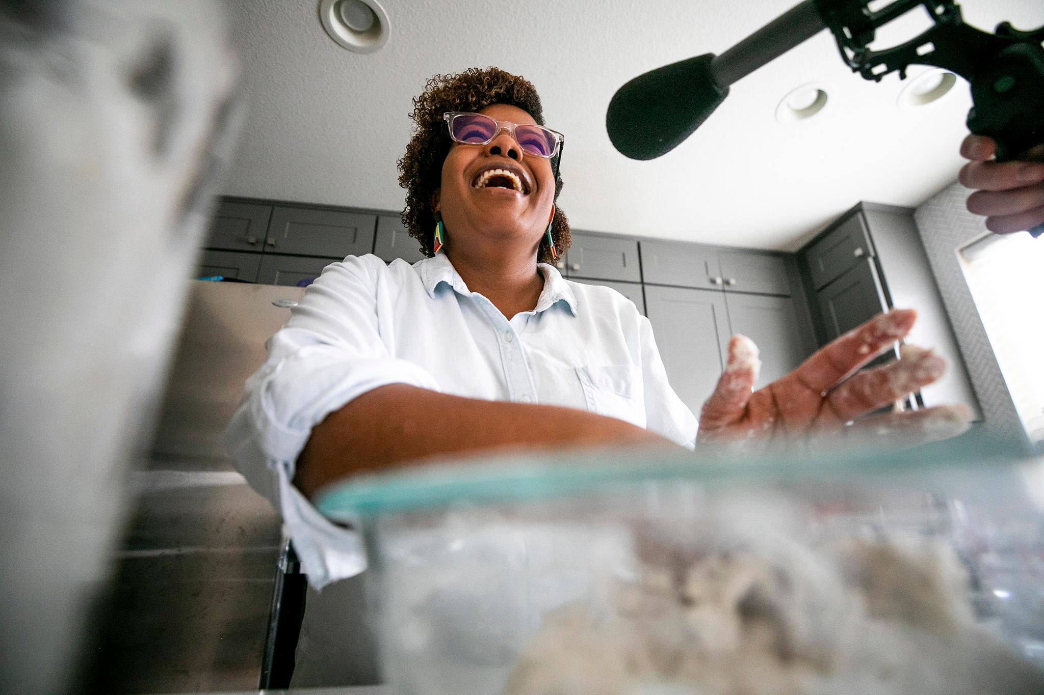 Althea Brown kneads roti dough in her Aurora home. Dec. 13, 2023.