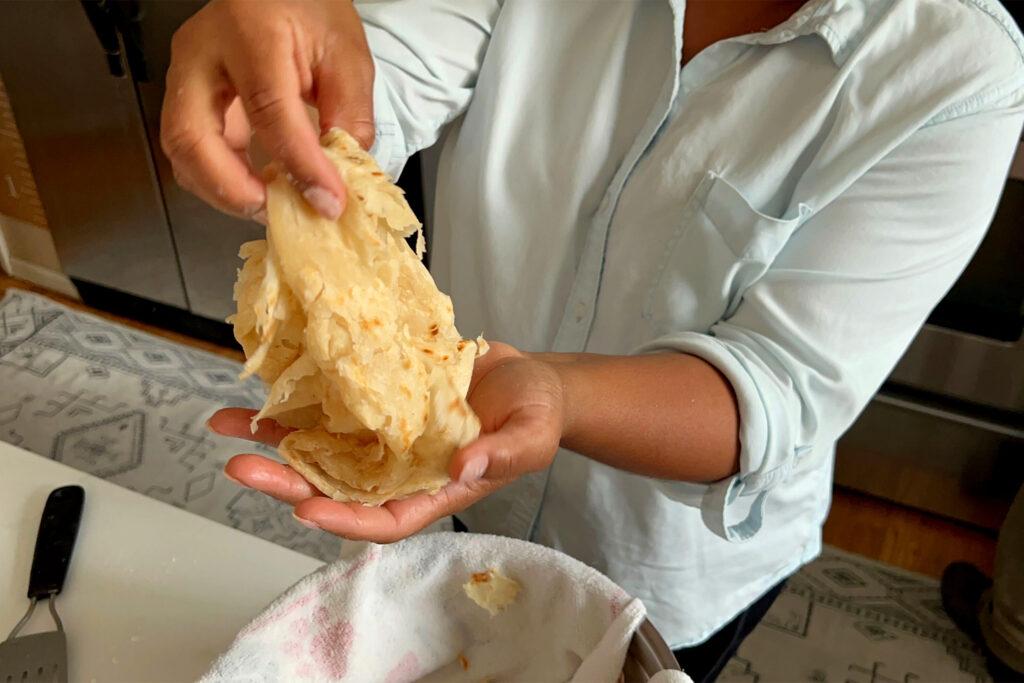 Althea Brown finishes fresh roti in her Aurora home. Dec. 13, 2023.