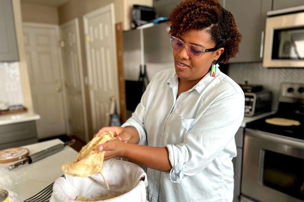 Althea Brown finishes fresh roti in her Aurora home. Dec. 13, 2023.