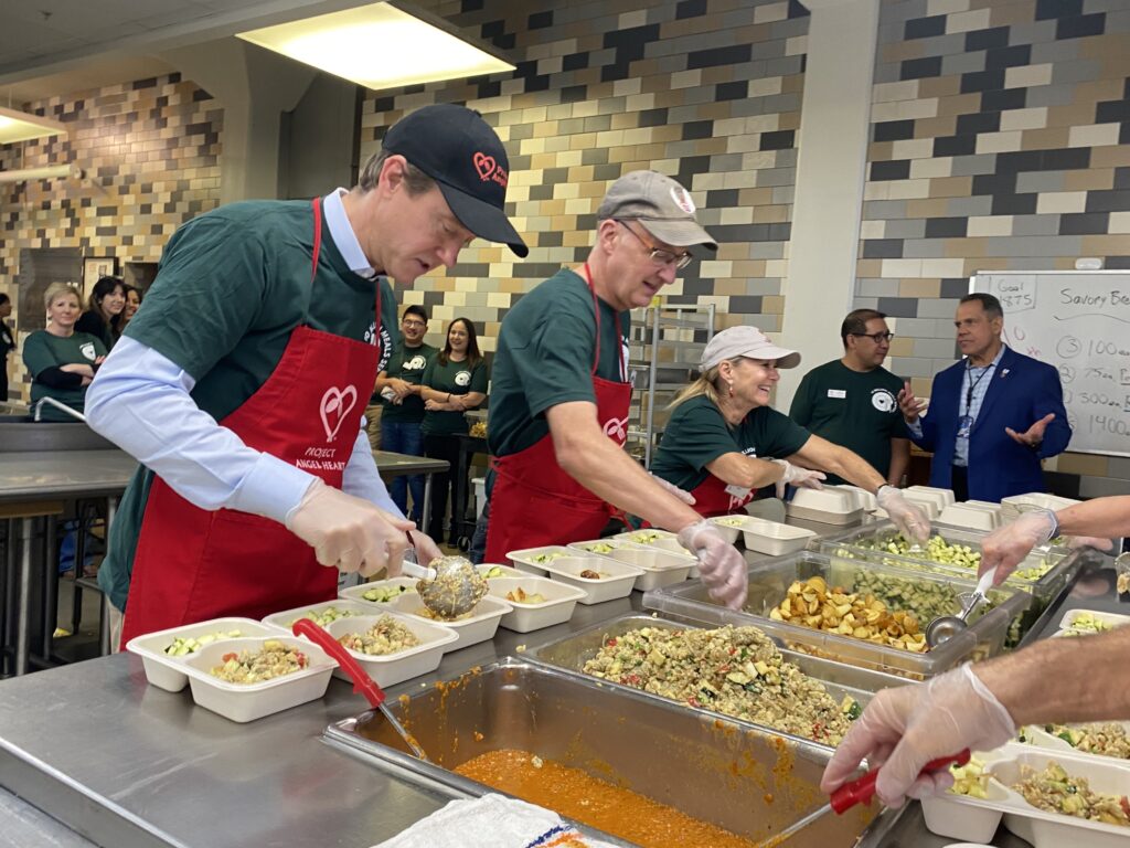 Denver mayor Mike Johnston prepares a meal at Project Angel Heart on Dec. 7, 2023.