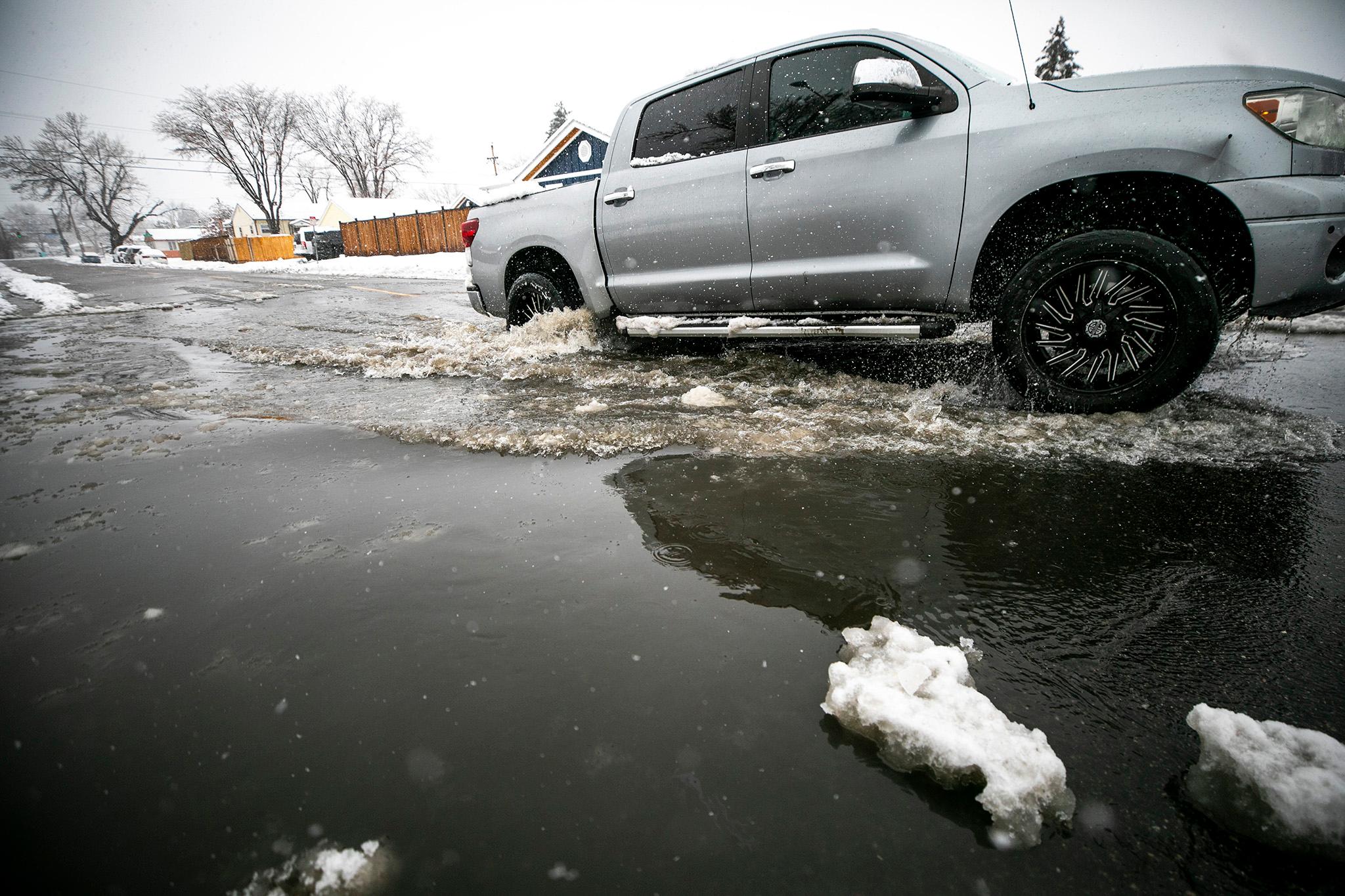 A driver emerges from an intersection-sized puddle in Mar Lee. March 14, 2024.