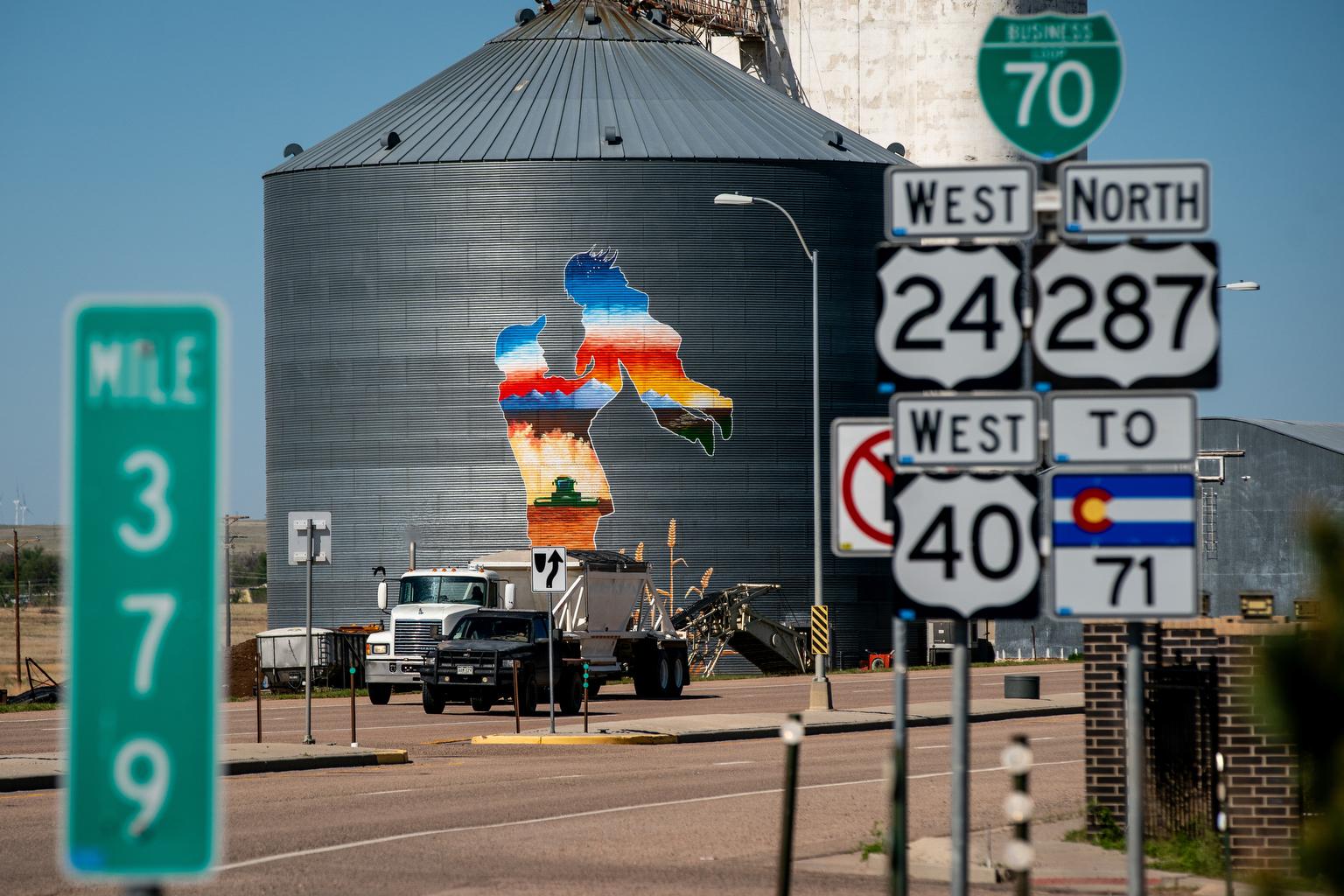 MURAL PAINTING OF FARMER ON SIDE OF GRAIN BIN