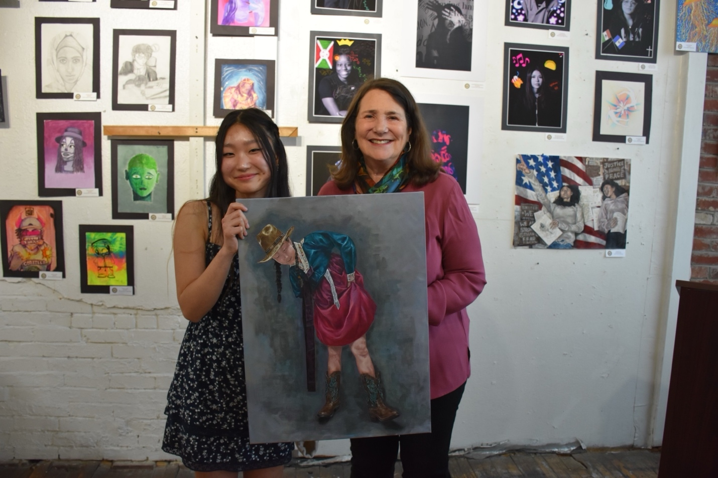 Congressional art contest winner Madison Lee and Congresswoman Diana DeGette together hold Lee's award winning painting.