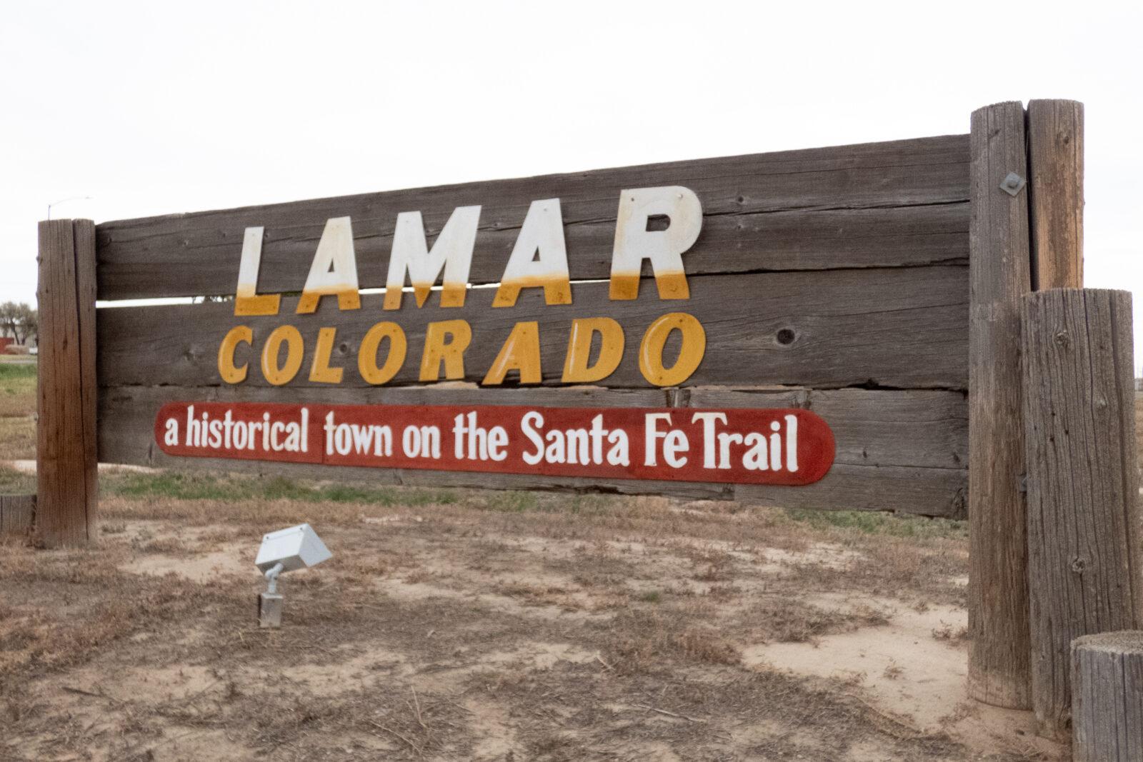 a large wooden sign that says lamar colorado a historical town on the Santa Fe Trail