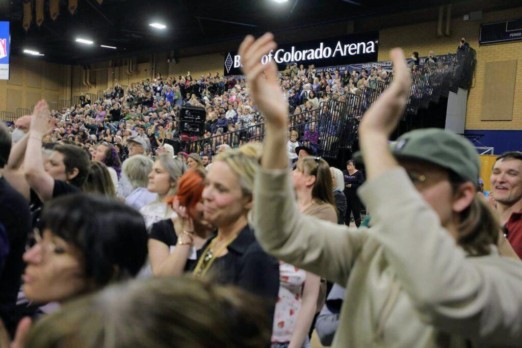A crowd cheers for Sen. Bernie Sanders and Rep. Alexandria Ocasio-Cortez
