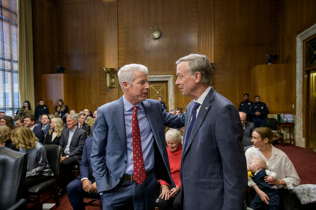 Chris Wright, left, talks with Colorado Sen. John Hickenlooper