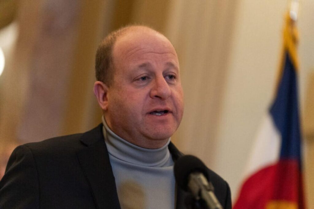 Governor Polis speaking into a mic
