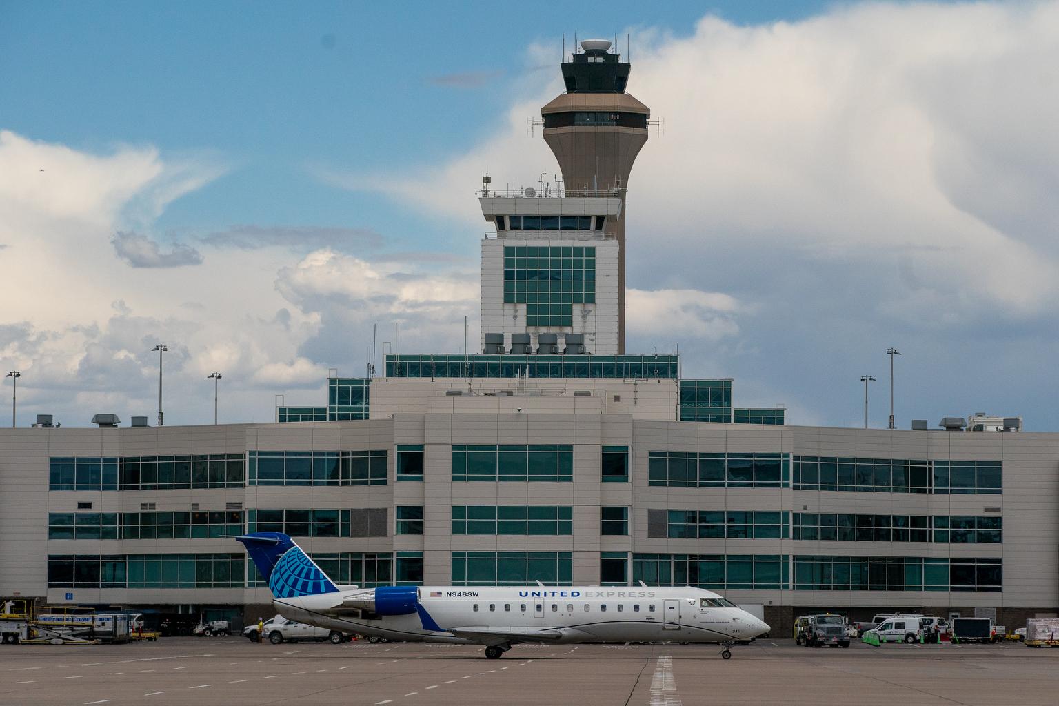 The control tower at Denver International Airport can be seen behind Terminal B