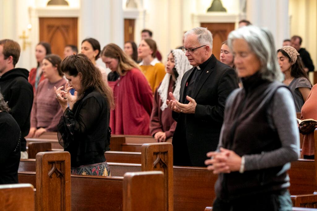 The congregation stands to pray