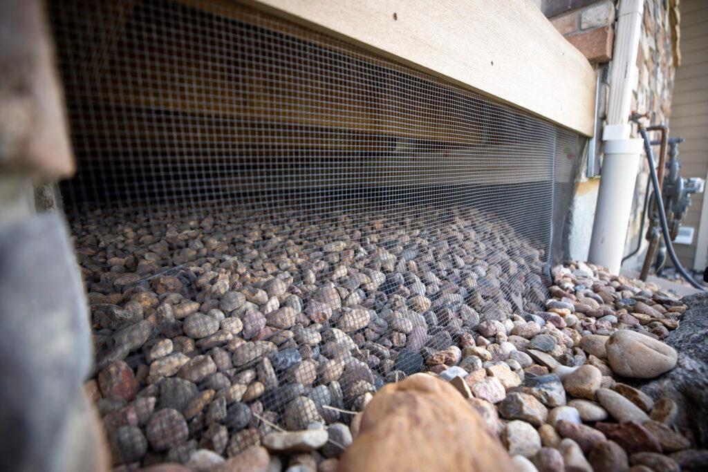 Mesh covers the space under Ann Brennan's porch in Louisville. May 28, 2025.