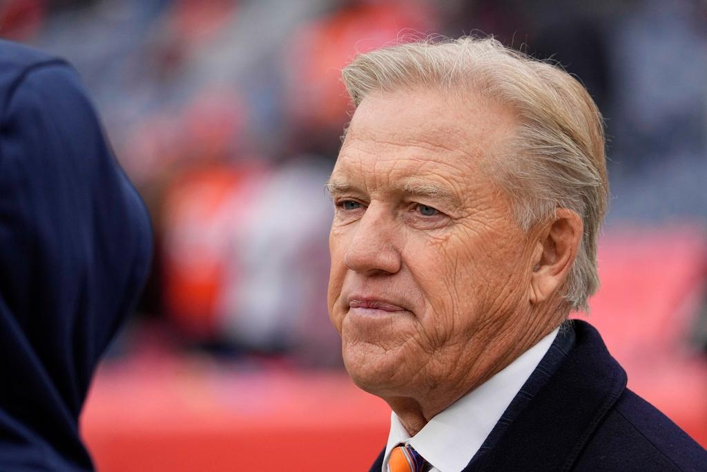 A man in a suit and graying blonde hair gazes out.
