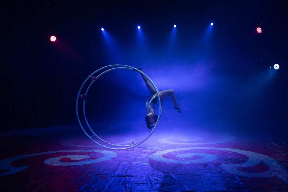 Women balancing on metal ring