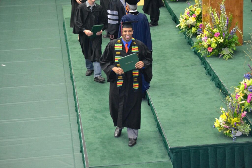 A smiling Eugene Daniels receives his college degree from CSU in 2012
