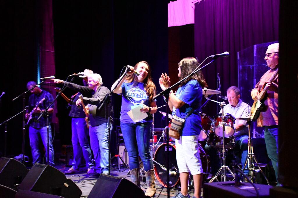 Musicians play on stage inside a theater