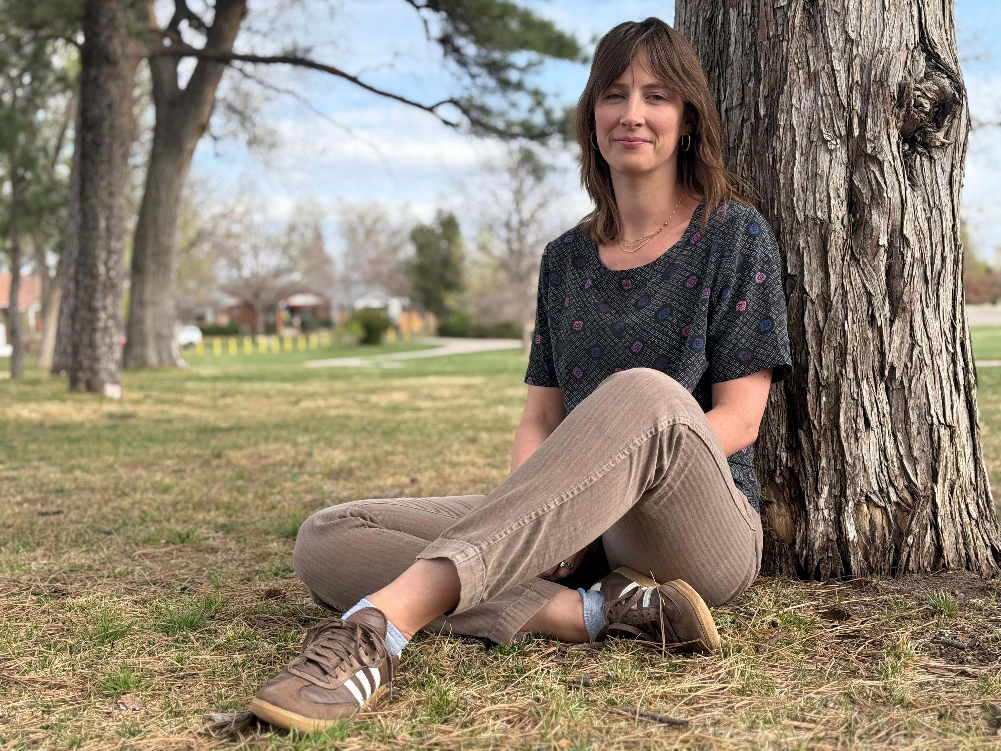 Woman sitting on grass outside