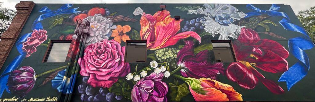 A large floral mural against an outdoor surface