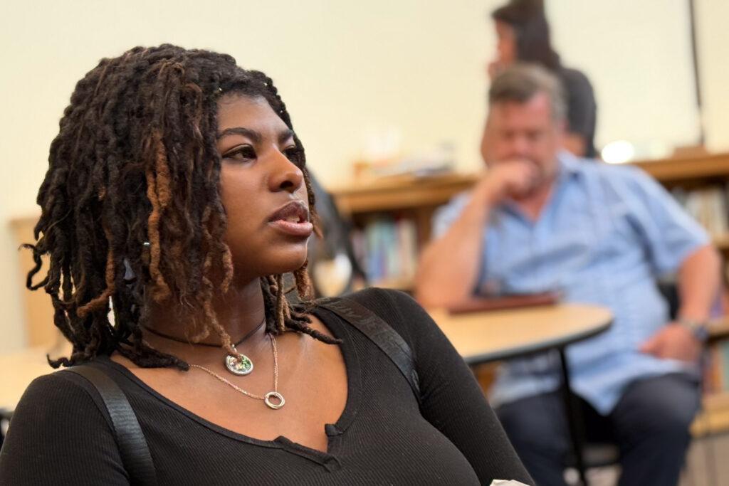 A side profile of a Black teenage girl in a classroom.