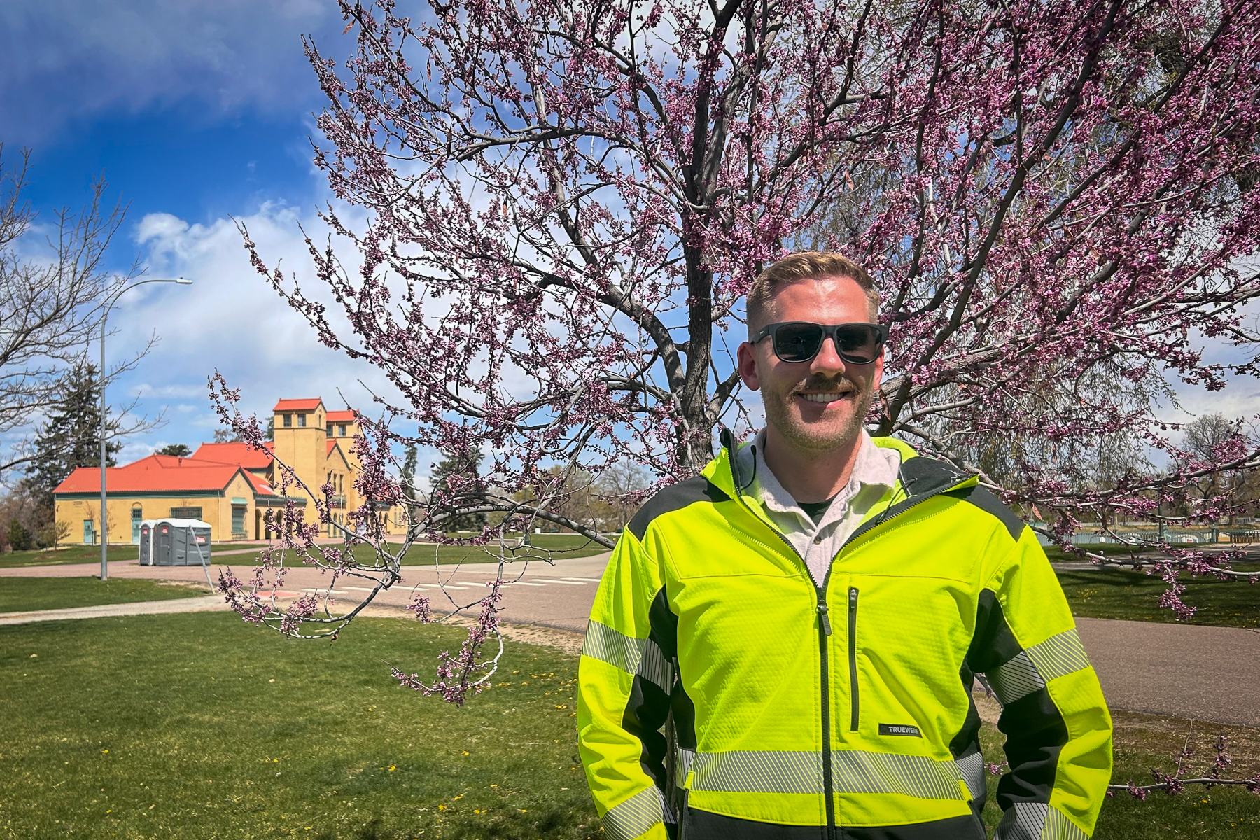 Man standing in front of flowering tree