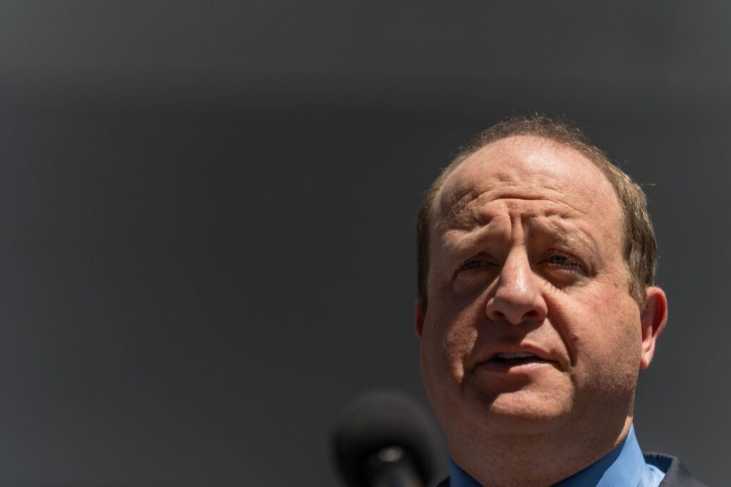 Colorado Gov. Jared Polis speaks to reporters