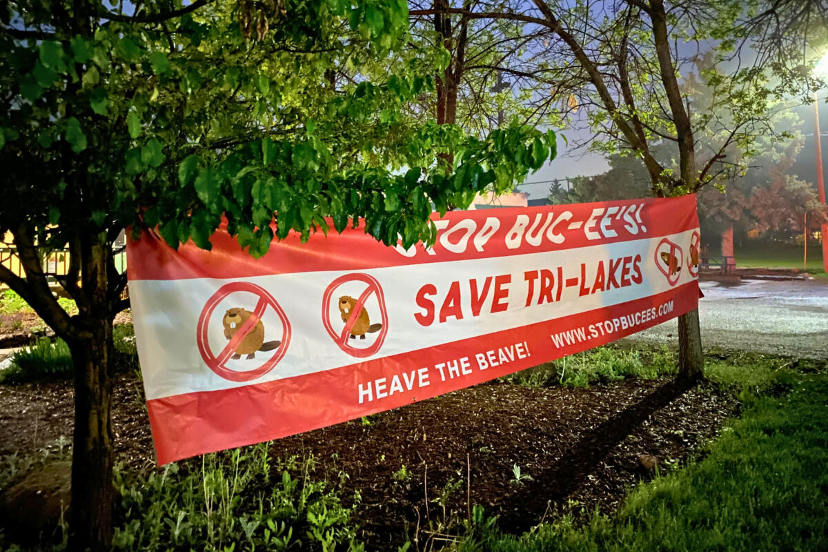 A large banner outside the Palmer Lake town hall reads "Save Tri-Lakes."