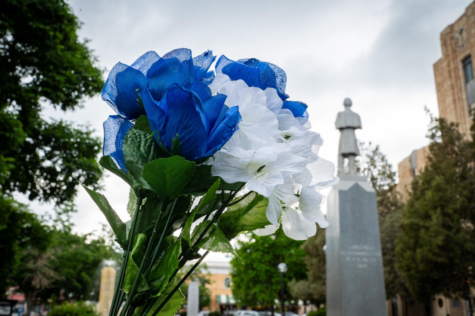 Flowers and flags adorn a makeshift memorial in Boulder