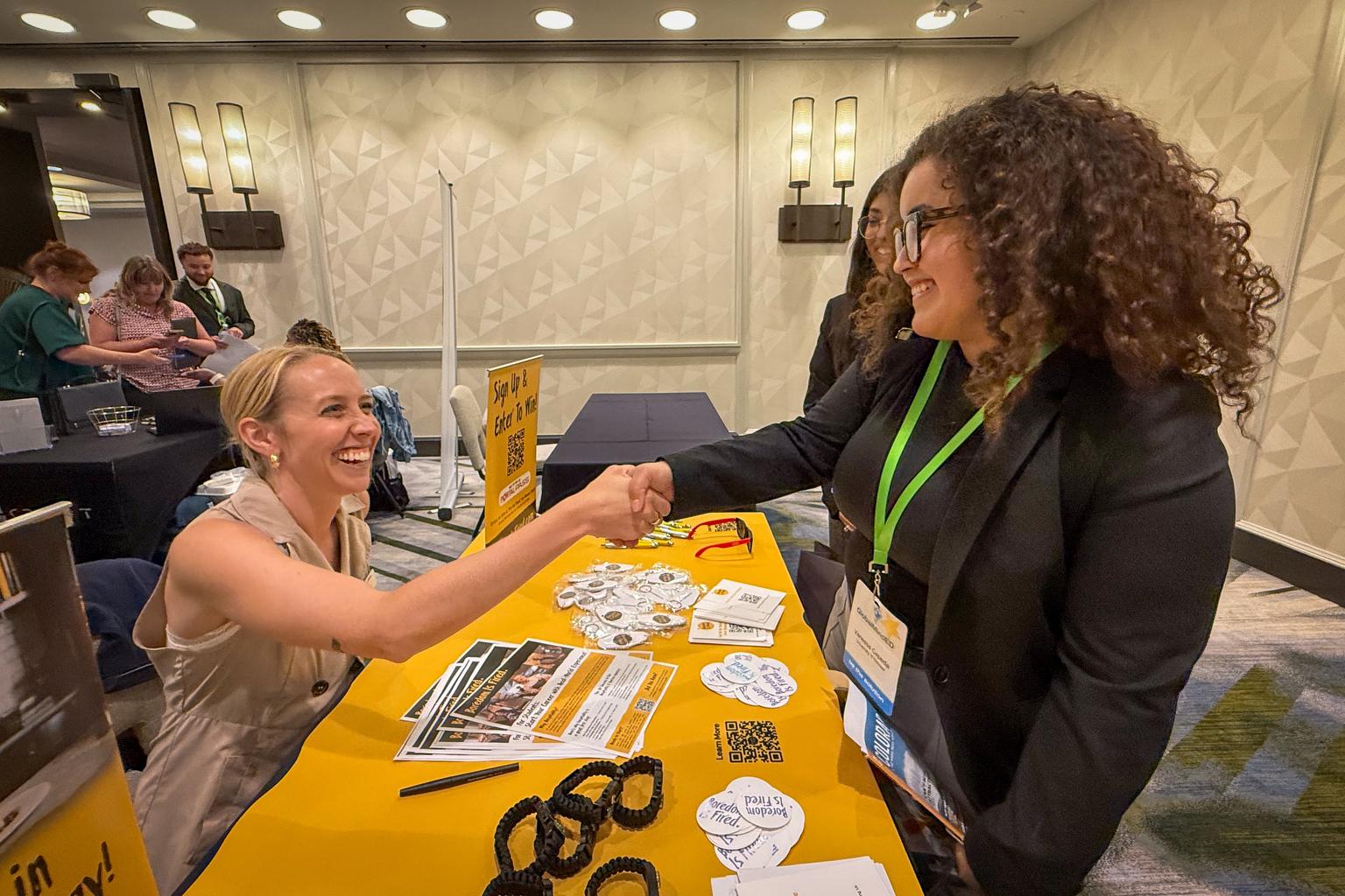 Vanessa Cepeda shakes hands with a job site representative