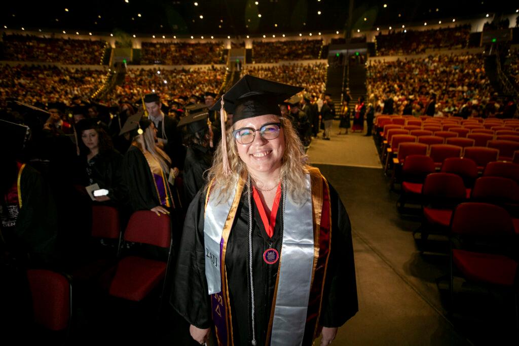 A woman graduates.