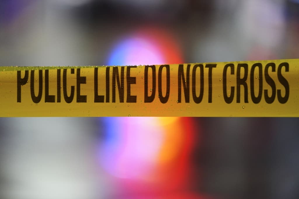 A yellow caution tape with black text is prominently displayed in the foreground, indicating a possible closure or cautionary situation. The background is blurred.