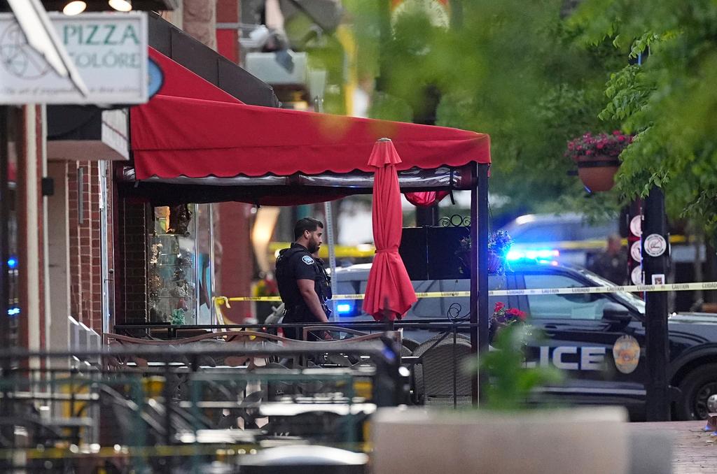 A police officer is standing under a red awning