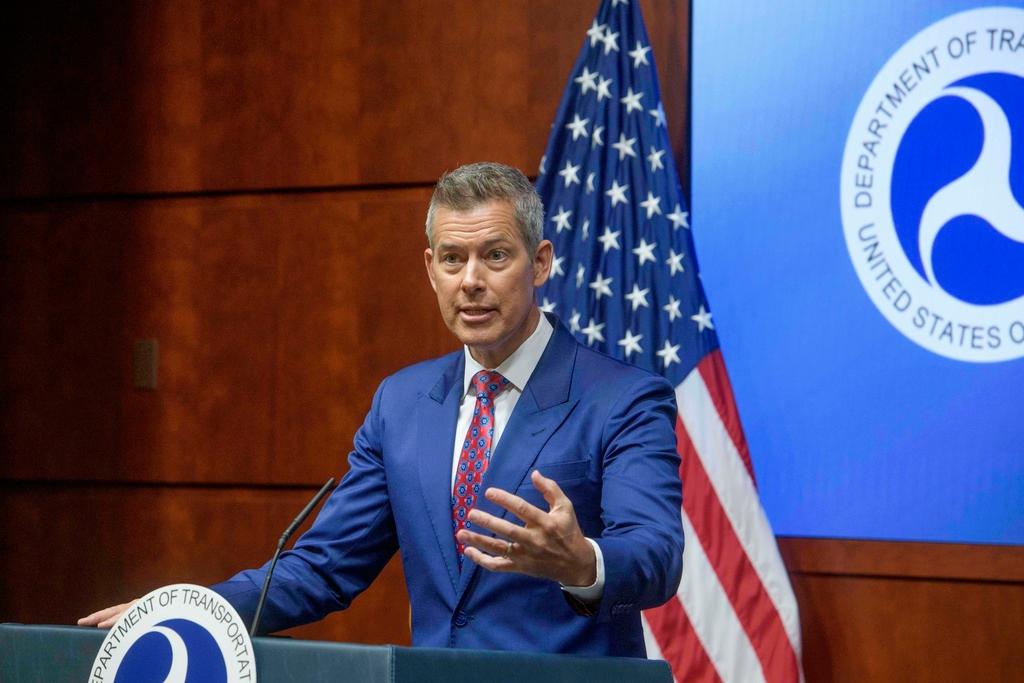 Man raises hand at podium