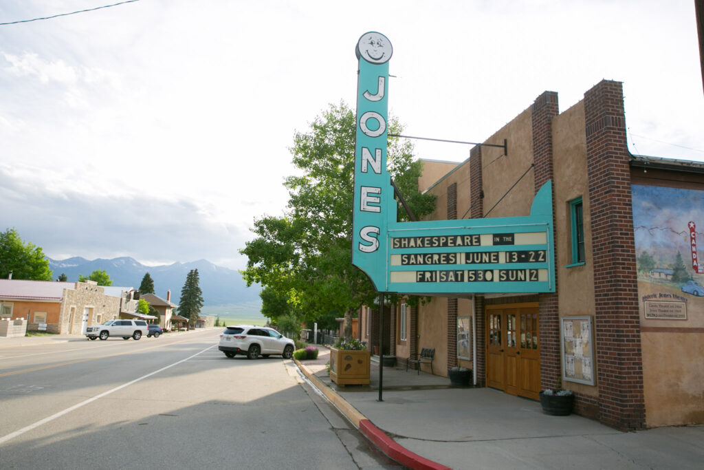 The exterior of the Jones Theater in Westcliffe, with Main Street and the mountains visibile.