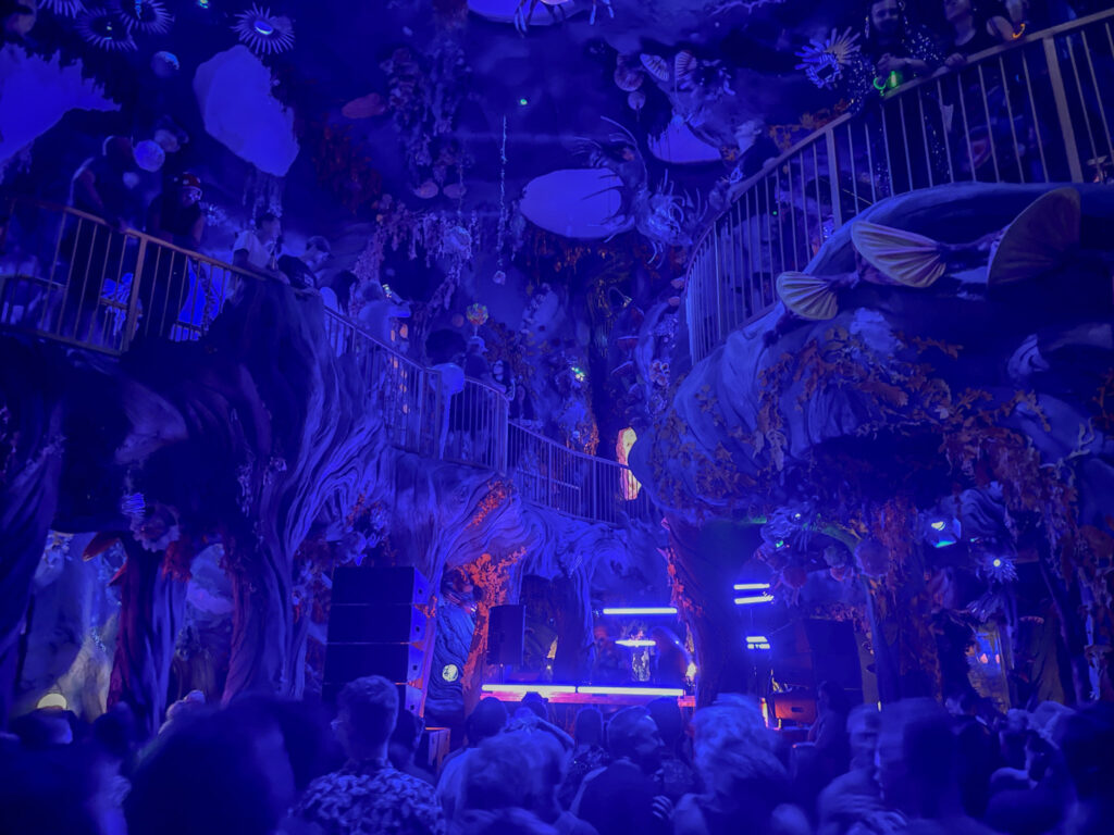 The jungle world at Meow Wolf veiled in purple.