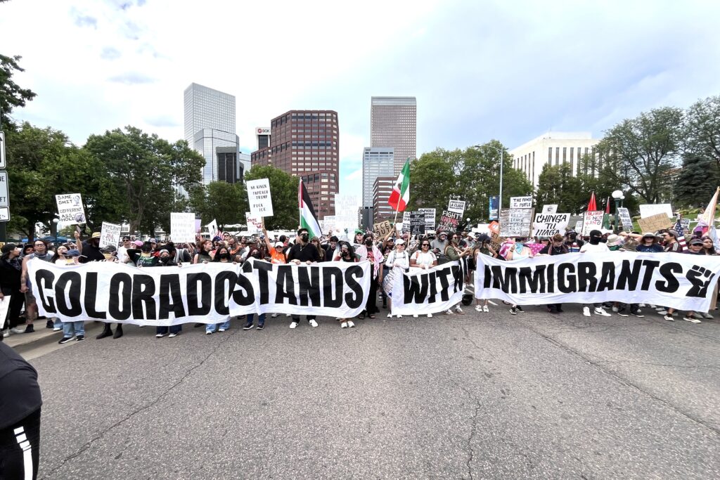 Protestors hold a banner across a street