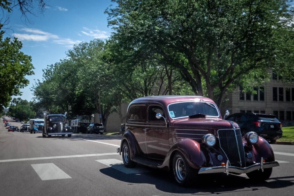 classic vehicles in a parade