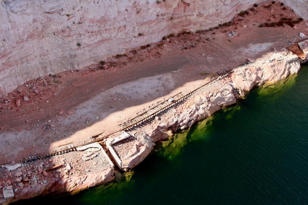 An aerial view of rocks and a green body of water